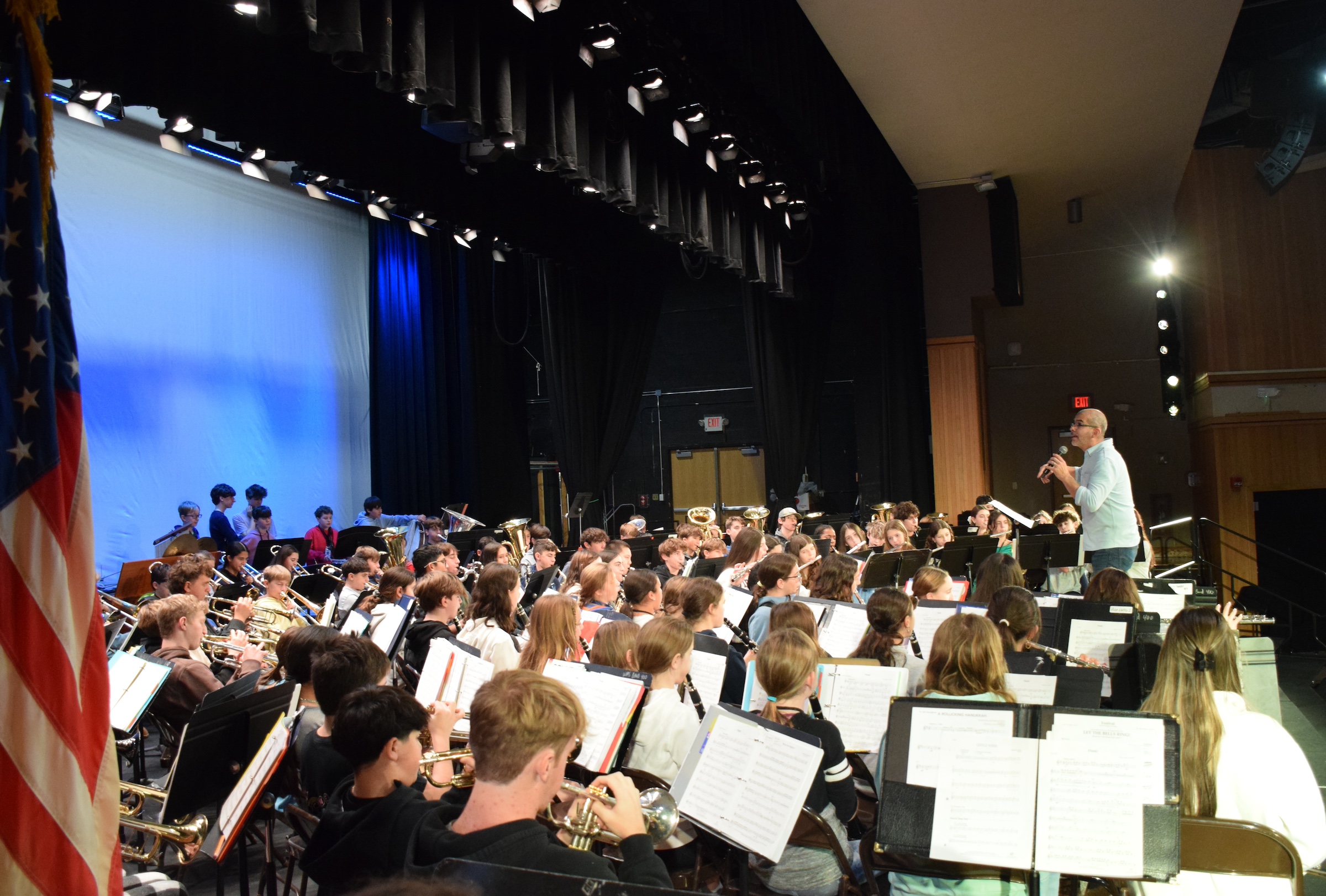 man conducting band students